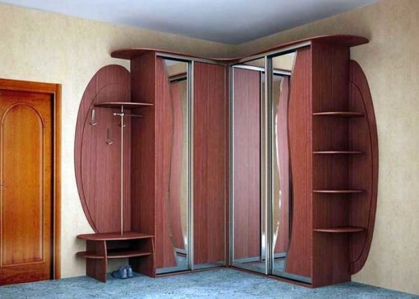 Corner wardrobe in the hallway is often complemented by a hanger and a small shelf for shoes