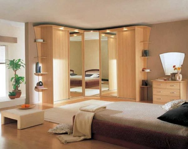 A corner wardrobe in the bedroom is a great way to hide all unnecessary