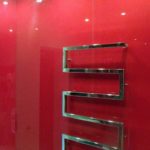 Painted bathroom walls can be protected with glass or polycarbonate panels