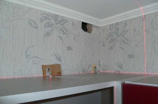 Kitchen cabinets are hung on corners with pads - to compensate for the difference in apron thickness