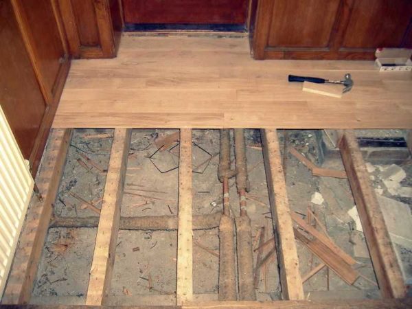 Laying a floor from a grooved board on logs is the most acceptable option