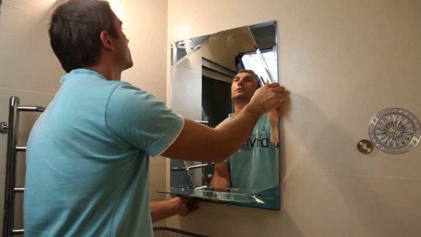 You can hang a mirror on the wall of the bathroom, corridor, hallway using fasteners, glue, mounting tape