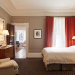 In the interior of a red bedroom, there may be some textiles, several decorative details.