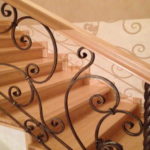 Forged stair rail with side attachment. The fasteners are made immediately built into the railing