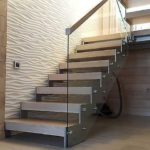 The handrail on the glass stair railing can be wood, plastic or metal