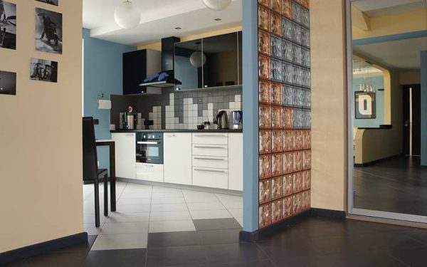 If you need to separate the kitchen from the corridor, but keep natural light in a dark corridor, put a glass partition