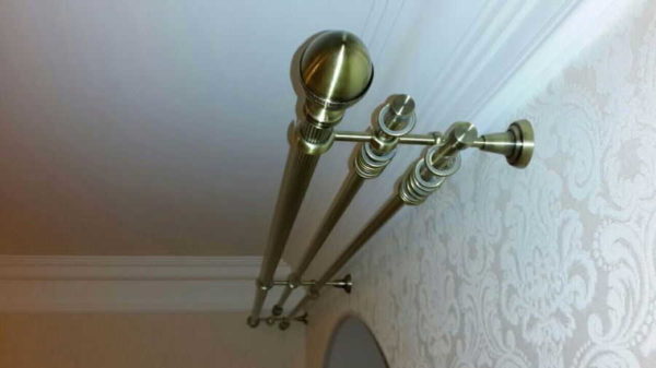 Three-row tubular cornice made of metal, plastic, wood - the most common options