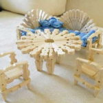 A round table for dolls from clothespins is not difficult to make