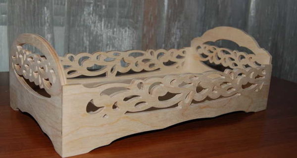 Carved wooden doll bed