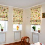 If the kitchen is too monotonous, you can add color using floral Roman curtains.