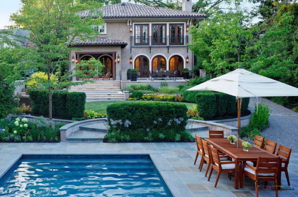 Landscaping of the courtyard of a private house with a pool near the door