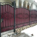 Another cold-forged fence on welded joints with a burgundy profiled sheet