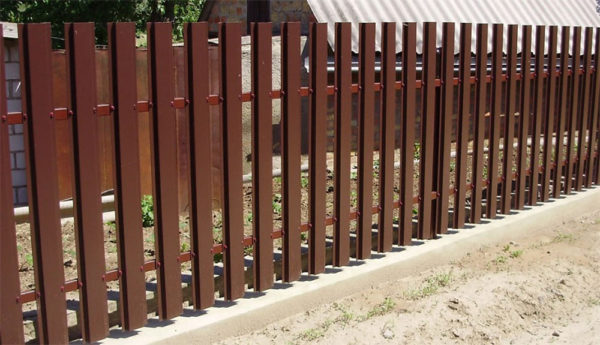Fence from a metal picket fence on a strip foundation