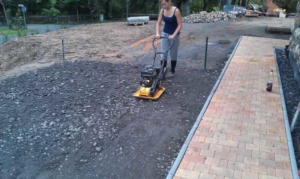 The best way to compact sand and gravel is with a vibratory plate.If not, you can make a homemade rammer. Take a log, attach handles, attach a solid platform (thick board) from below. By picking up and throwing this implement, compacting sand / rubble