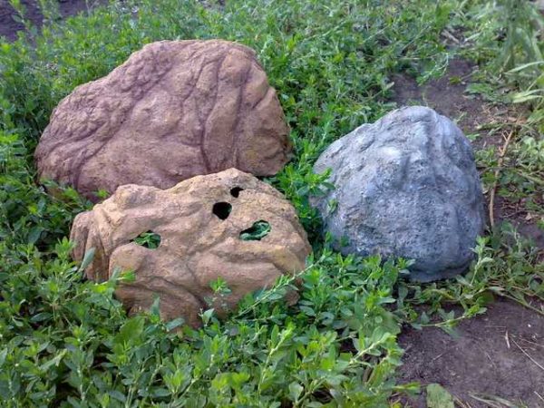These are concrete stones, but they are hollow inside. The base can be molded from clay, coated with several layers of concrete. When everything is dry, crumble the clay