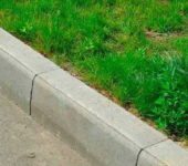 A curb separates roads and paths from lawns and squares