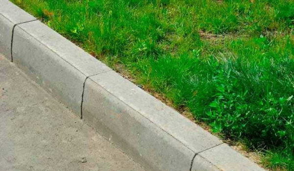 A curb separates roads and paths from lawns and squares
