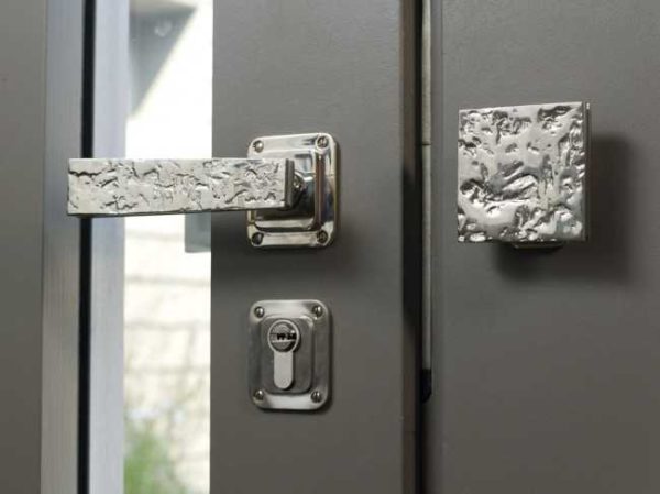 On double doors there is a set - a handle with a latch and a stationary